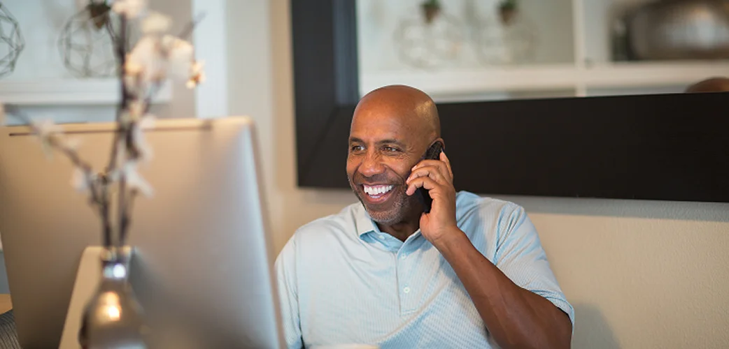 Person speaking on phone in an office setting